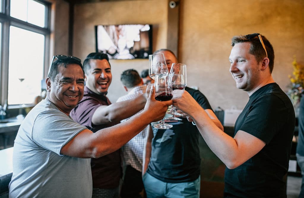 Friends toasting wine together at Joseph Cellars