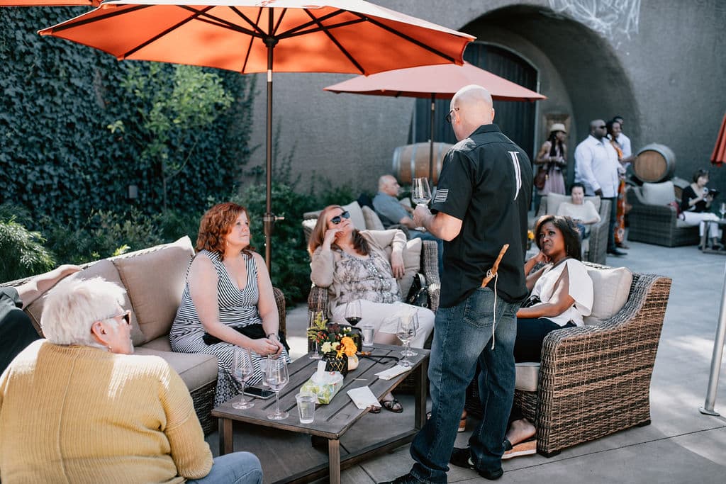 Guests enjoying wine on the Joseph Cellars terrace with Palisades views